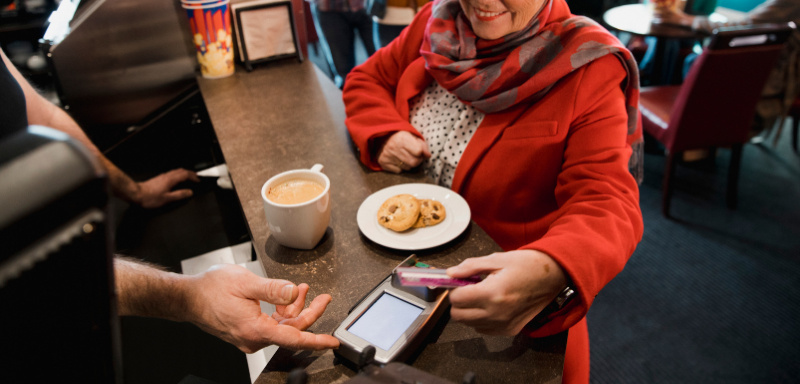 woman using credit card pay coffee