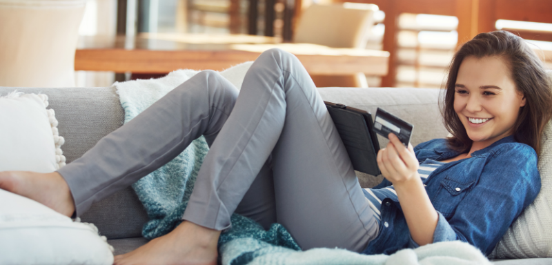 woman using ipad for online purchase with credit card